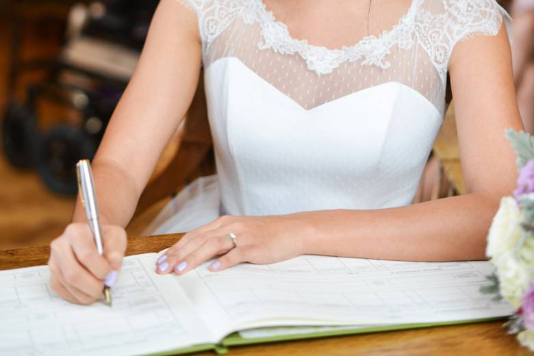 Bride is signing the register
