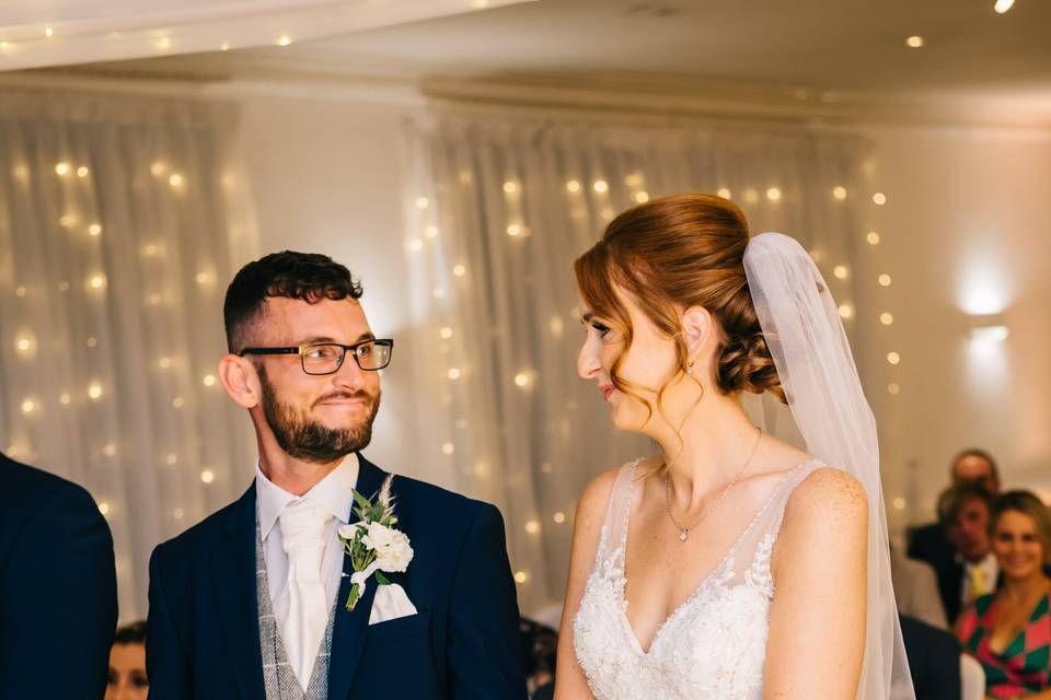 Groom smiling at bride