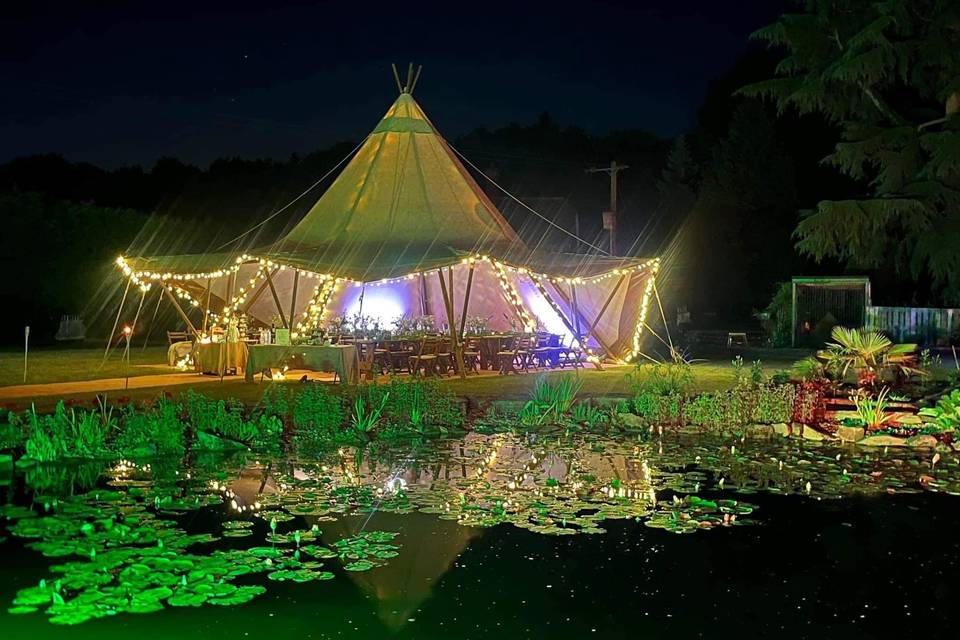 Tipi and pond at night