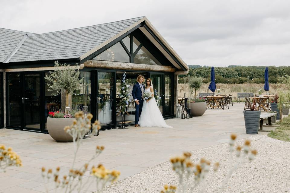 Couple outside wedding barn