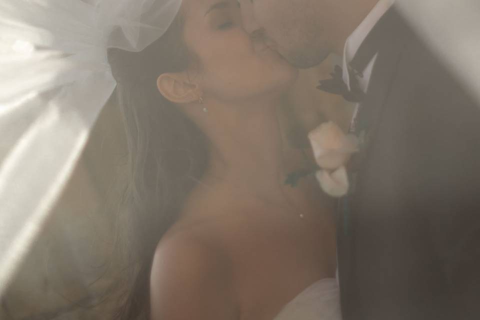 Couple kissing under veil