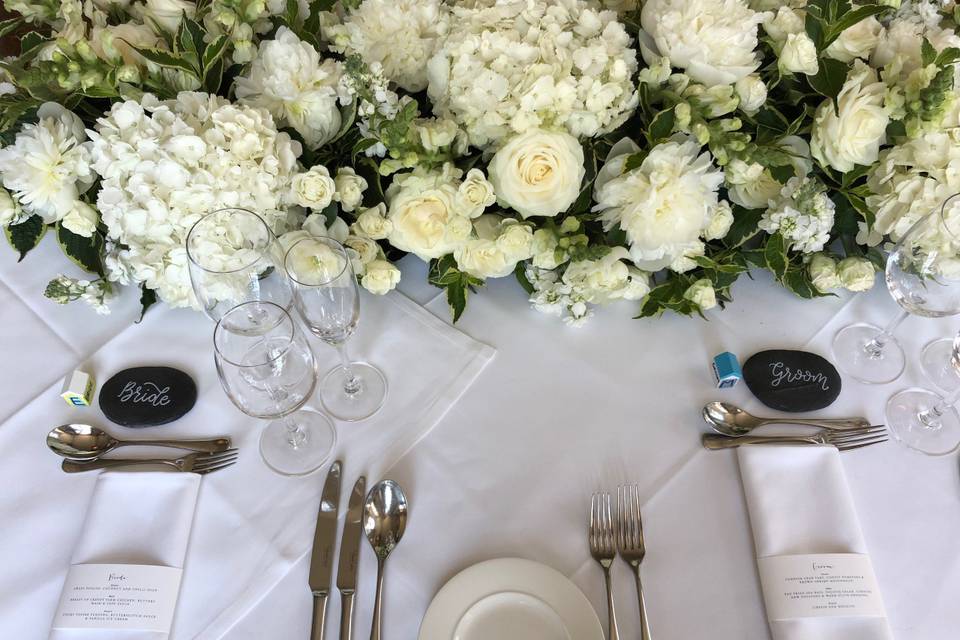 Green and white floral arch