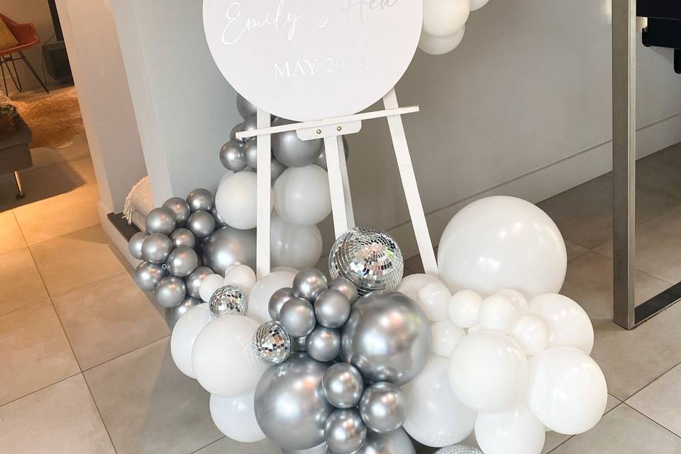 White easel with disco balls