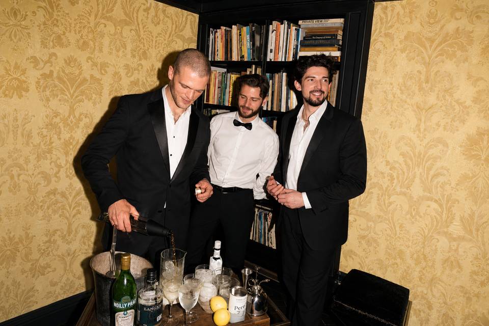 Three friends behind a bar