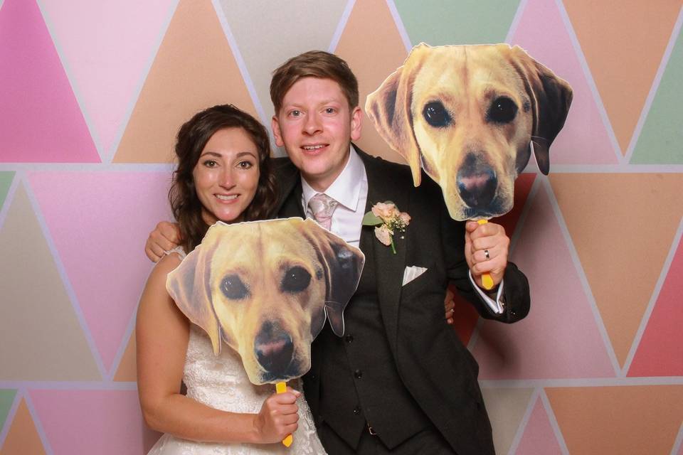 Couple holding dog masks