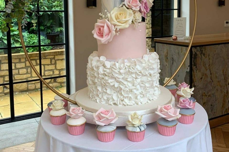 wedding cake with cupcakes