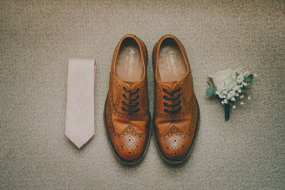 Groom shoes and flowers