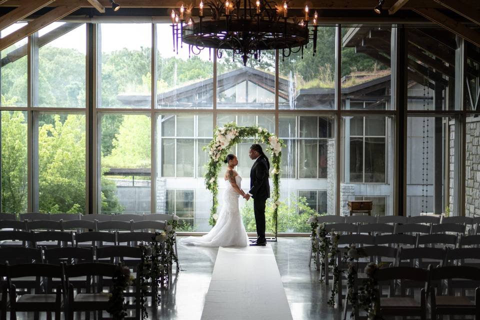 Standing in front of the floor-to-ceiling windows