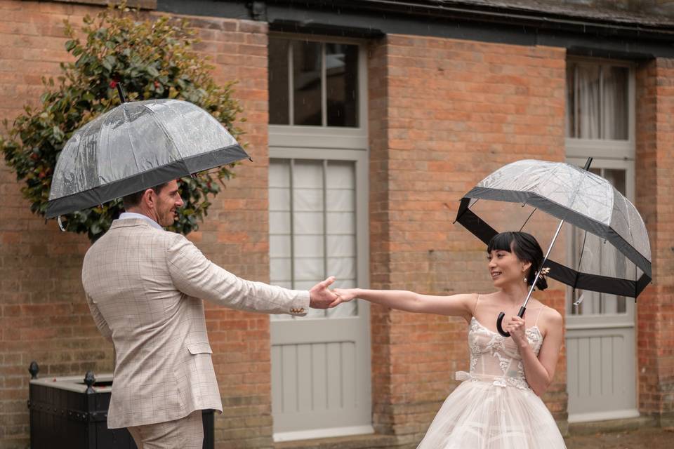 Bride and groom under the rain