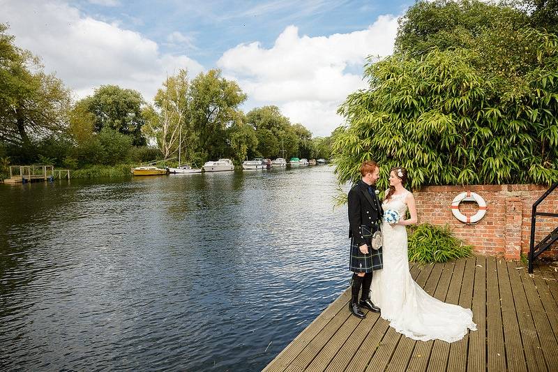 Bride and Groom by River in Summer
