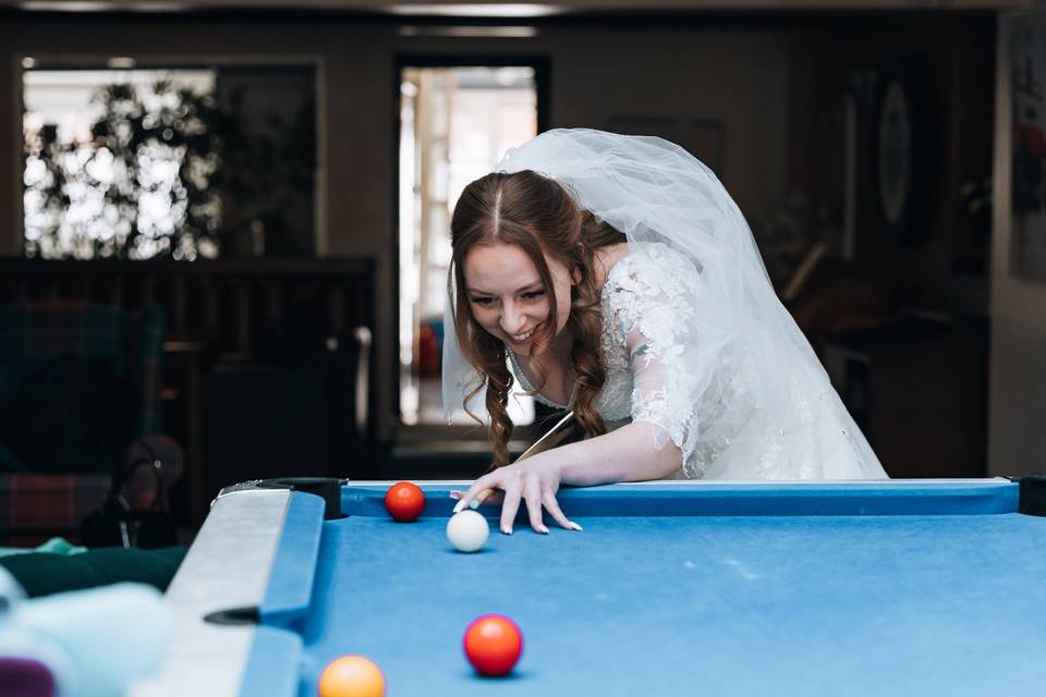 Bride playing pool