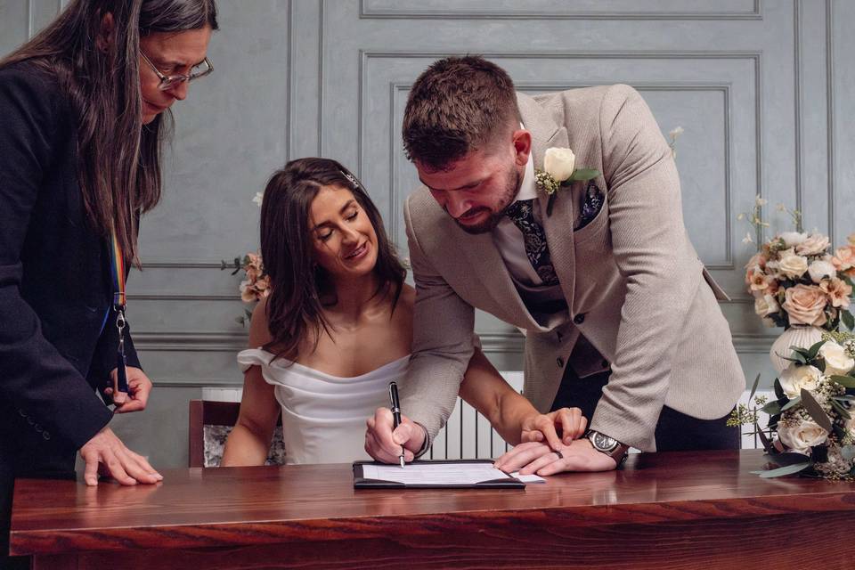 Groom signing papers