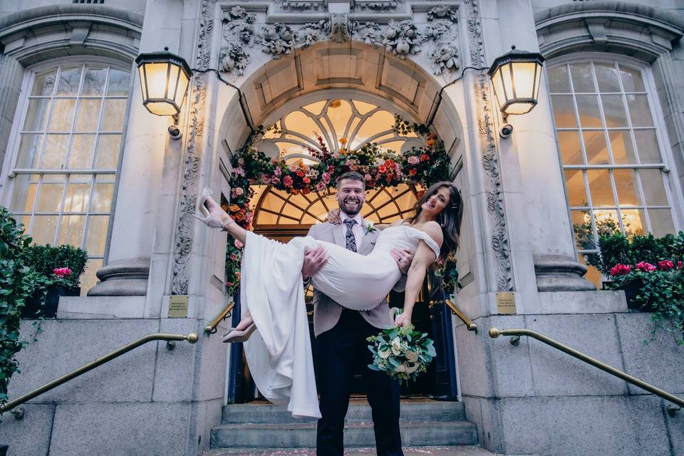 Groom carrying bride