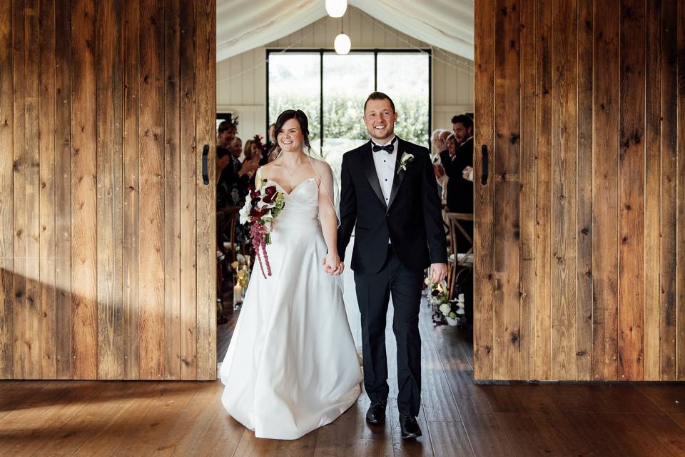 Bride and groom hold hands