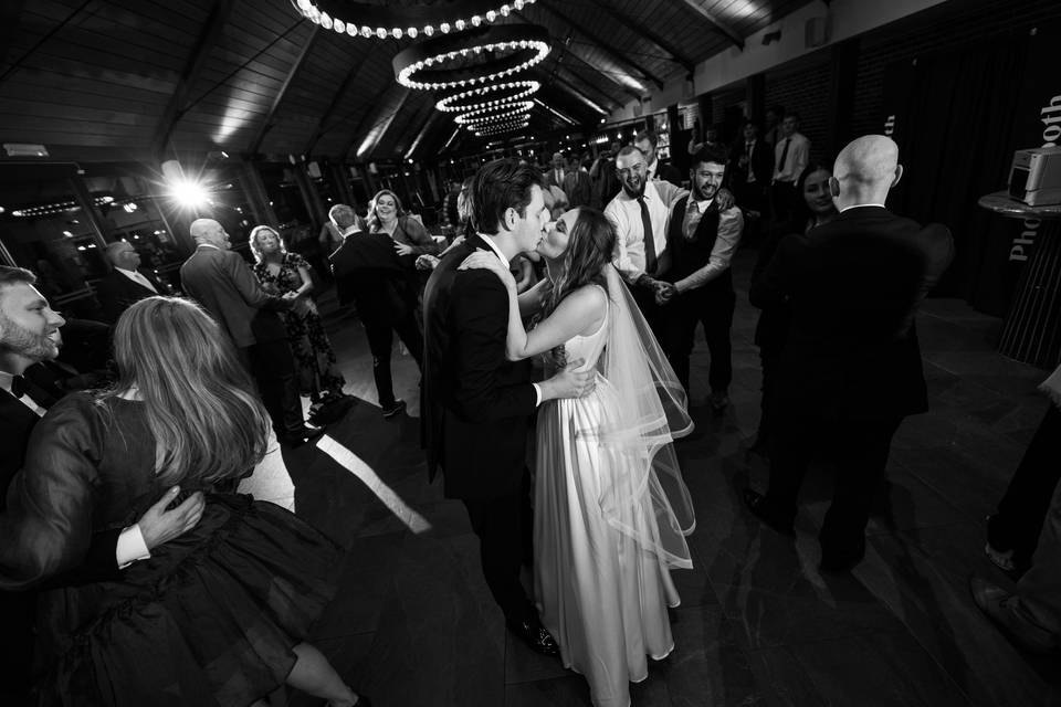 A bride and groom kiss