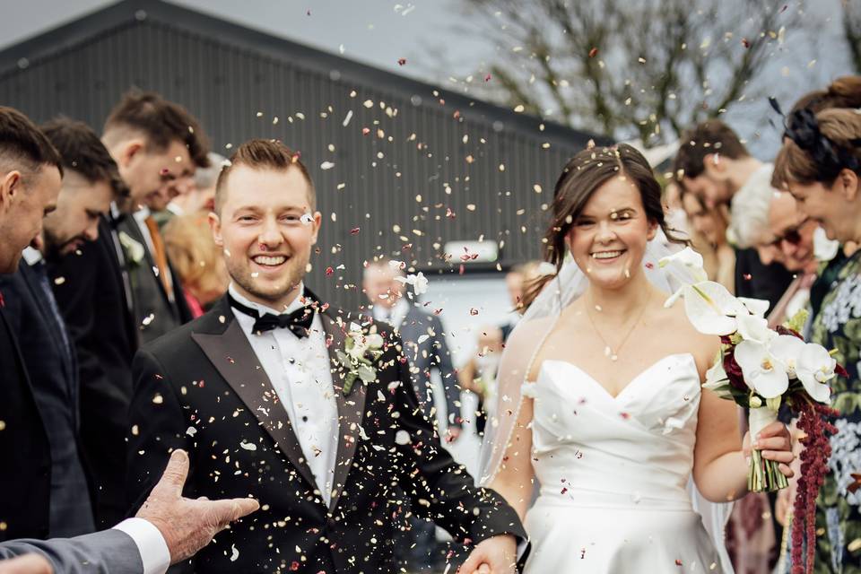 Bride and groom confetti walk