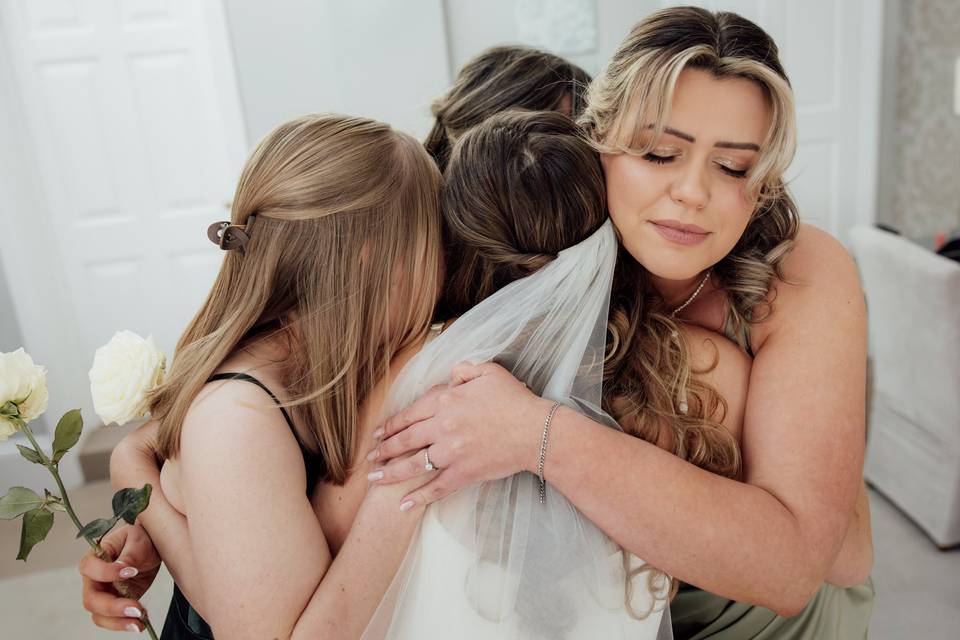 Bridesmaids share a group hug