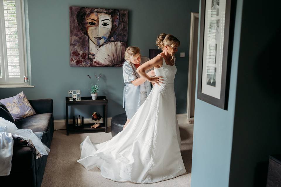 Putting on the bridal dress