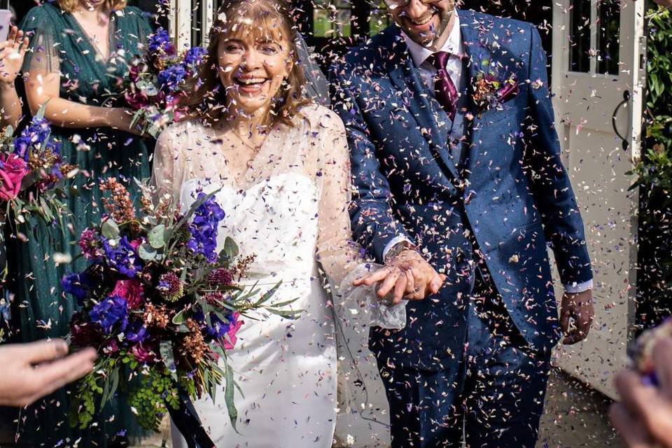 Flowergirl with Rainbow Delphinium Petals. The Real Flower Petal Confetti Company