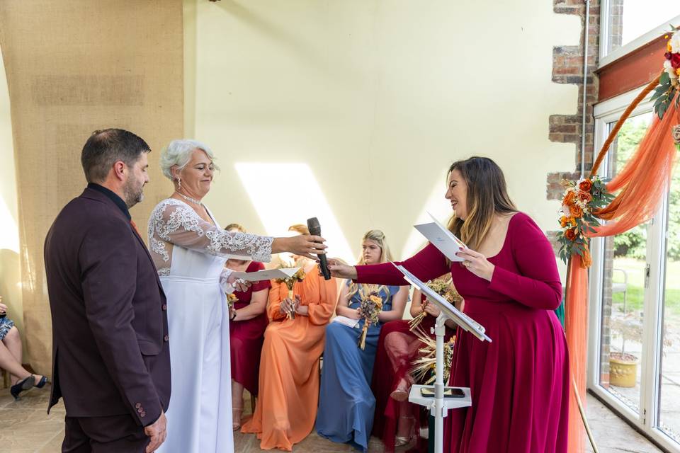 couple holding hands at wedding altar