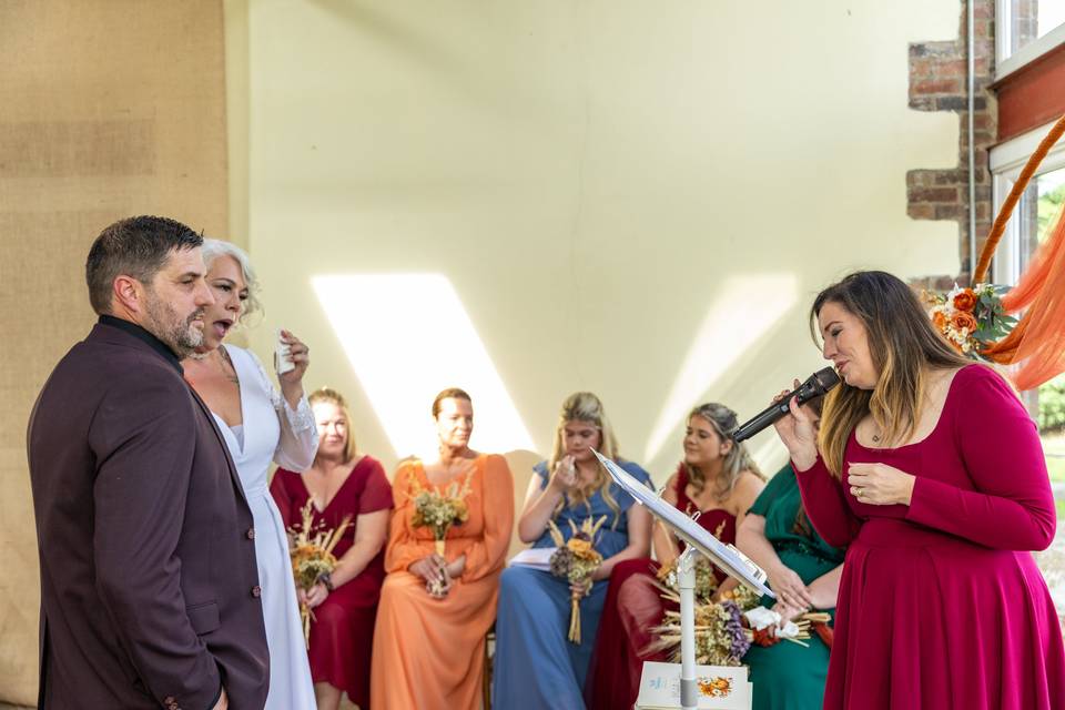 groom watching bride walk down aisle