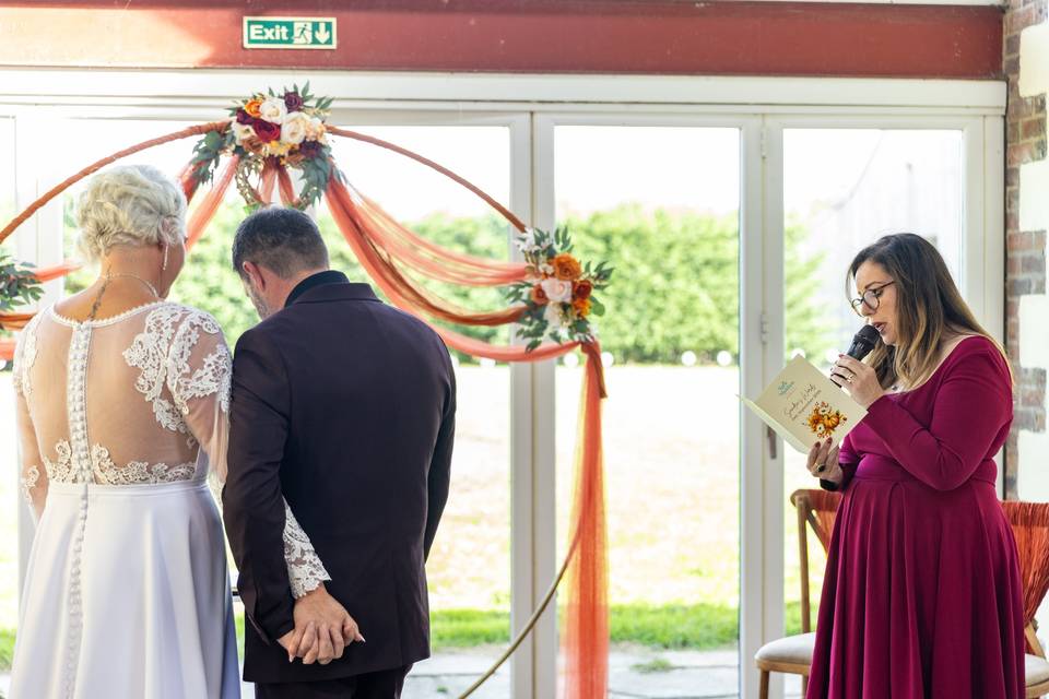 wedding couple standing with minister