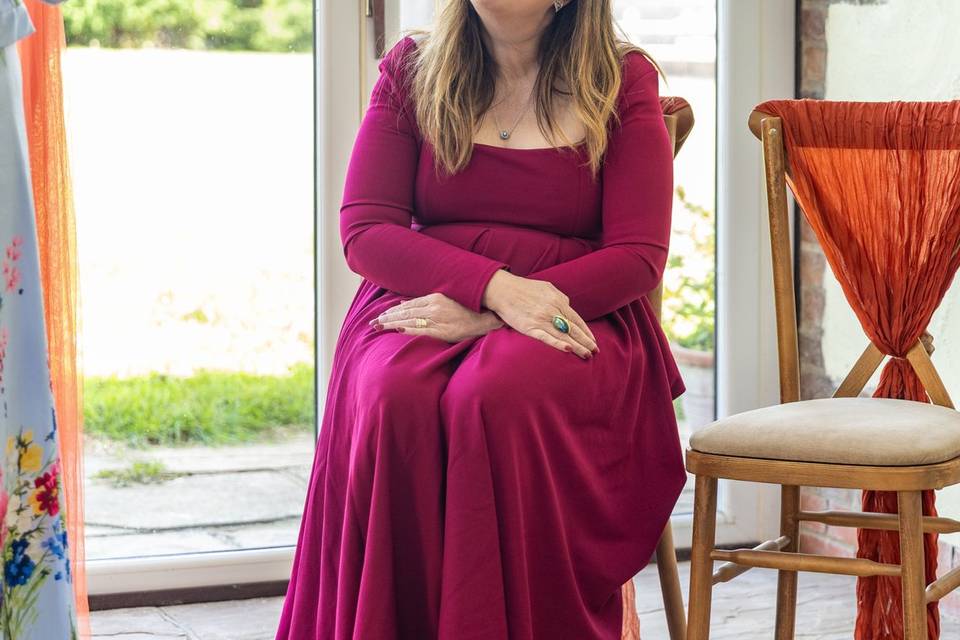 woman in red dress at wedding ceremony