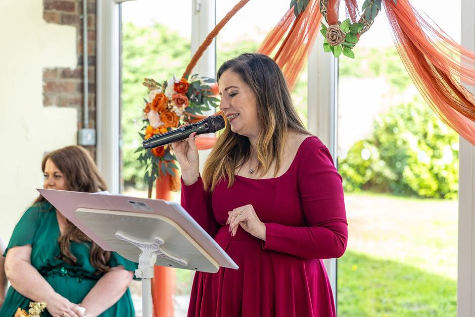 woman reading at wedding lectern