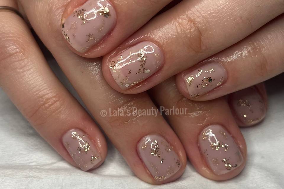 Gold glitter on nude nail