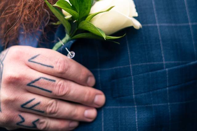 Groom admiring his flower
