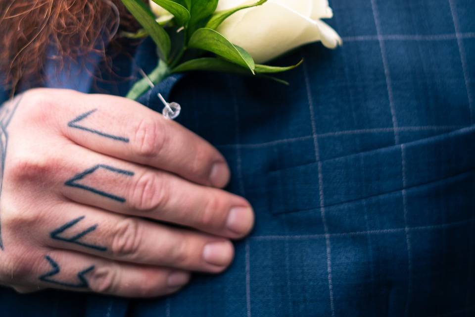 Groom admiring his flower