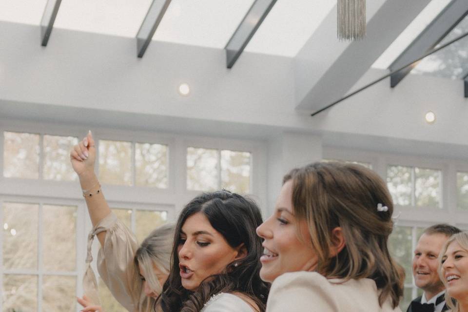 Bride and bridesmaid dancing