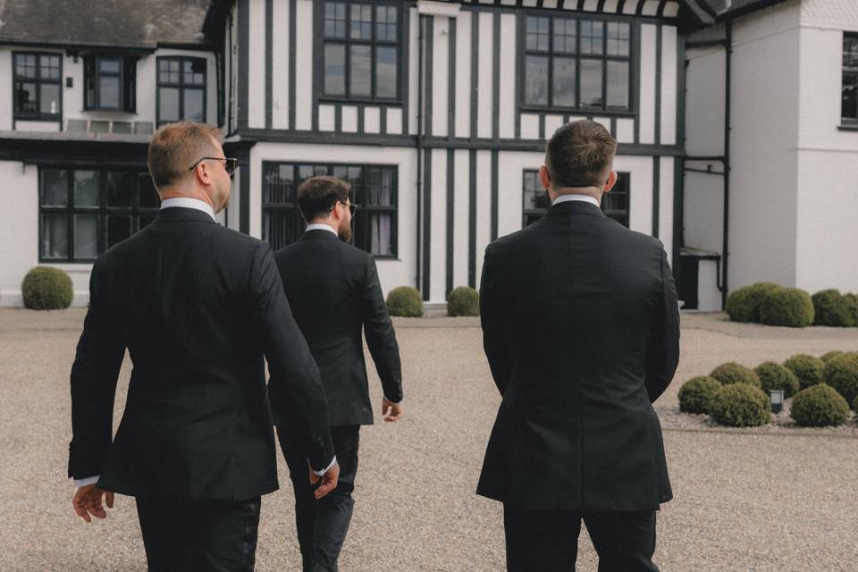 Groomsmen walking into venue