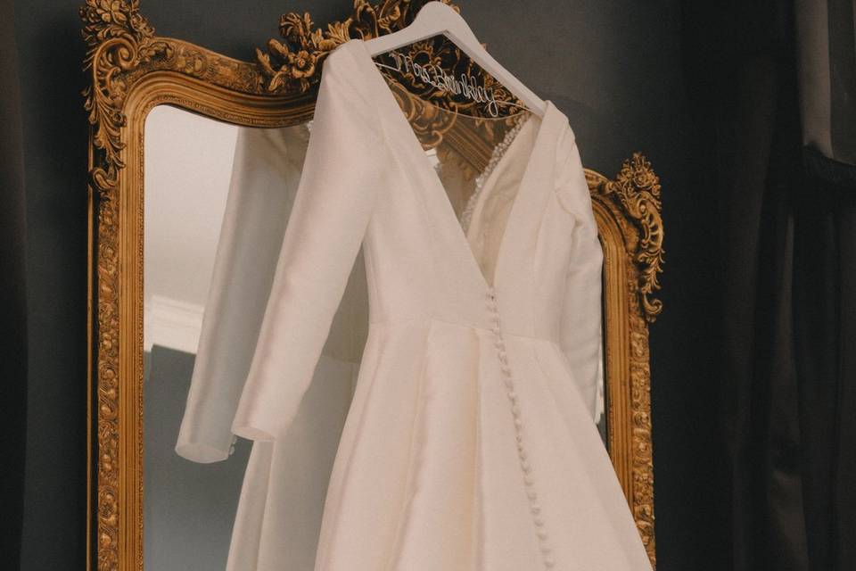 Bride dress hanging on mirror