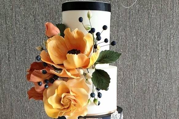 Bold and bright sugar flowers on wedding cake