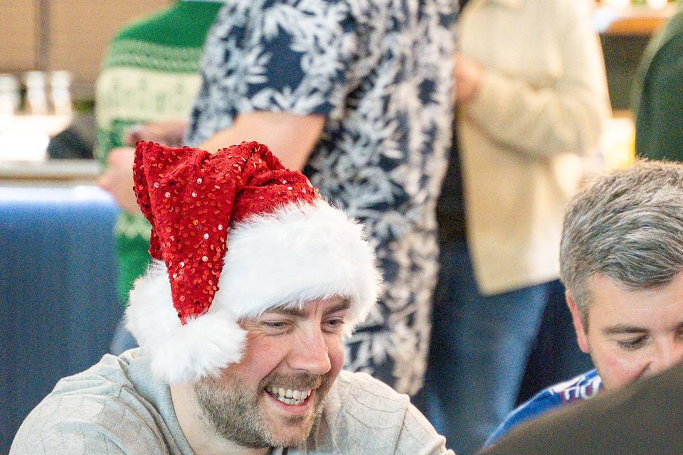 Smiling guest in Santa hat