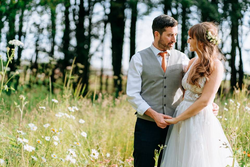 Bride and groom amongst flowers