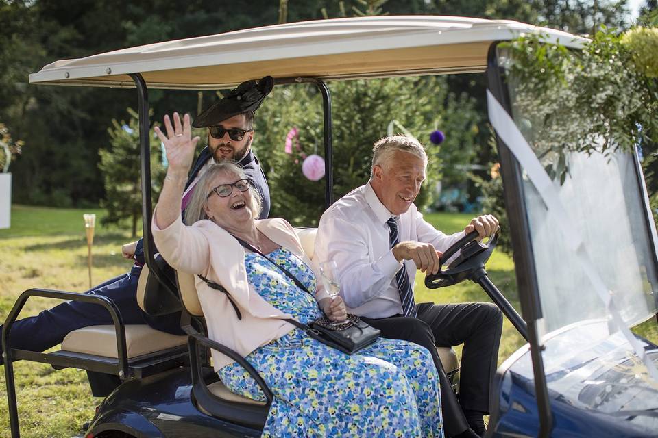 Enjoying a lift in the golf-cart