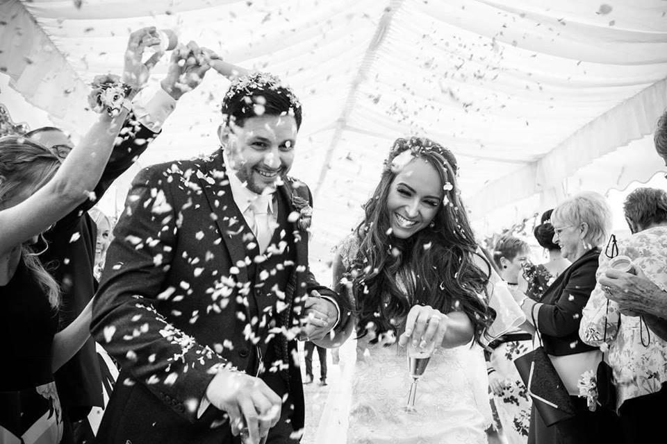 Newlyweds covered in confetti