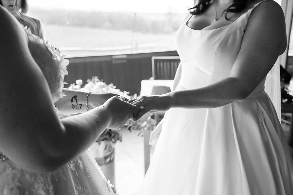 Two brides exchanging rings