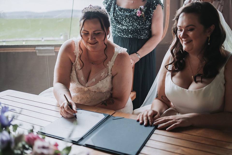 Brides signing register