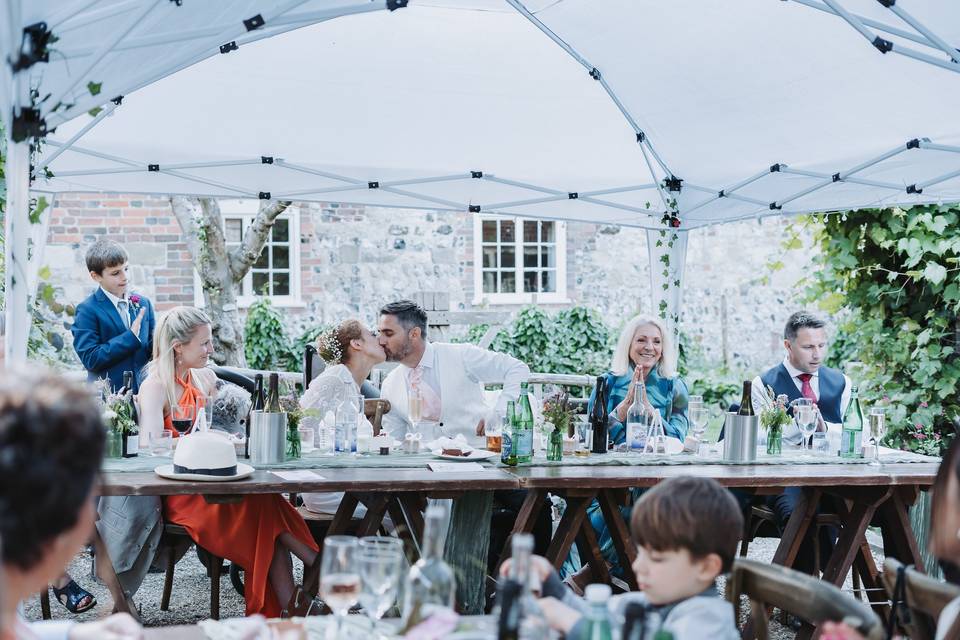 Bride & groom kiss top table