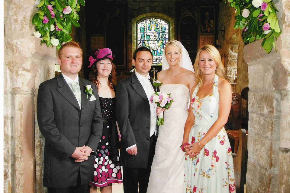 Church arch and wedding party