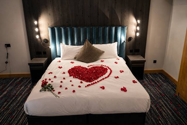 Rose petals on bed