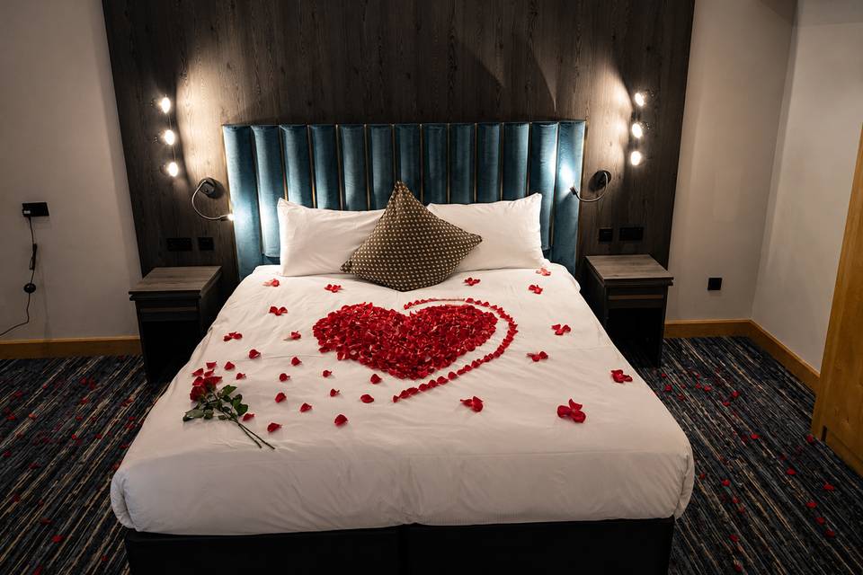 Rose petals on bed