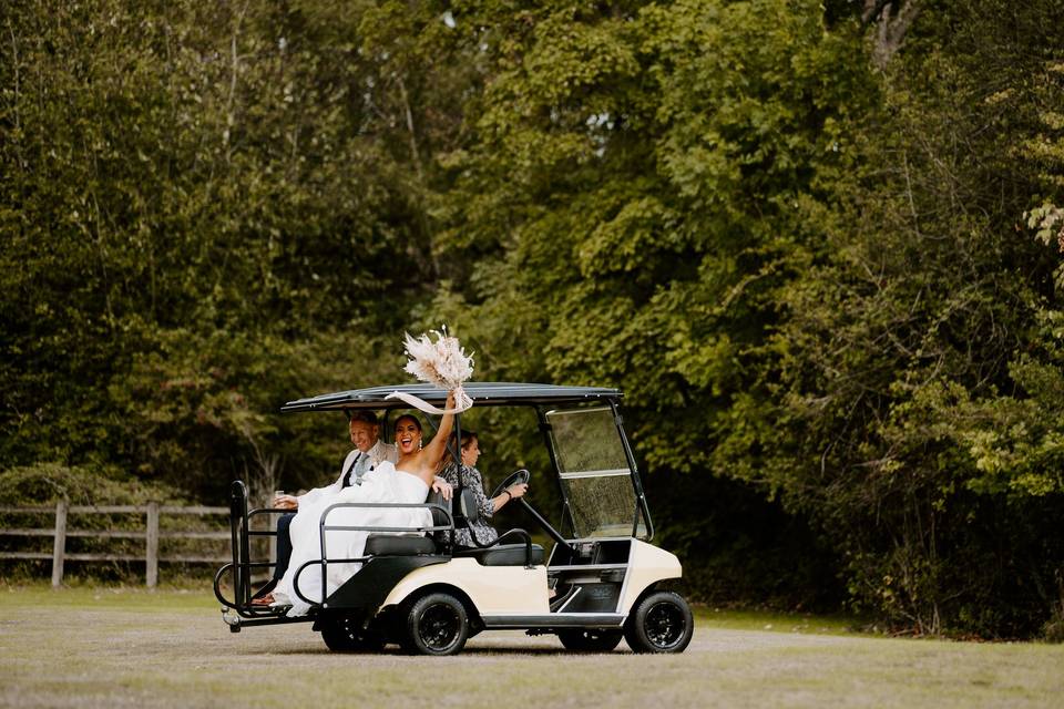 Bride and groom golf cart ride