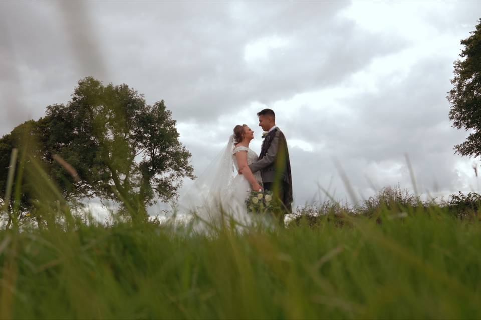 Newlyweds in a field