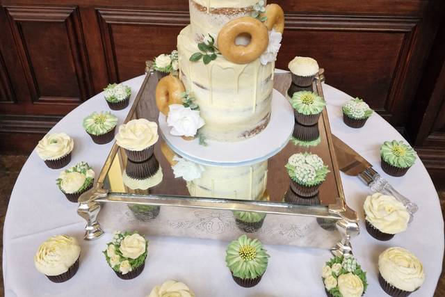 Tiered cake and cupcakes