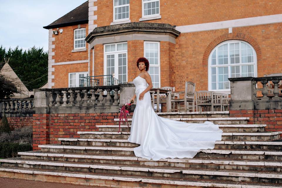 Bride on wedding venue steps