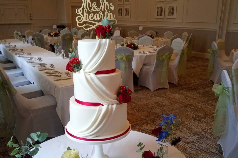 White and red cake with drapes